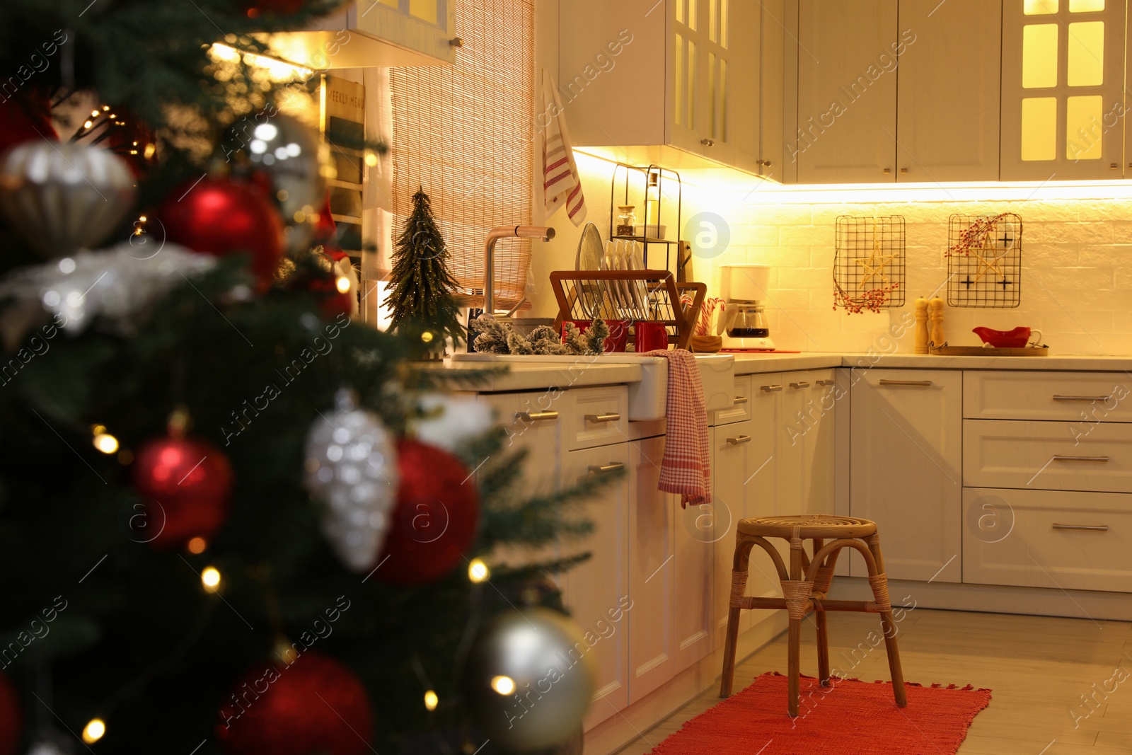 Photo of Cozy kitchen interior with Christmas tree and beautiful festive decor