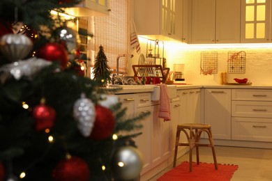 Photo of Cozy kitchen interior with Christmas tree and beautiful festive decor