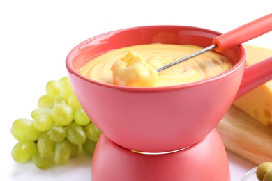 Delicious cheese fondue with grapes on white background, closeup