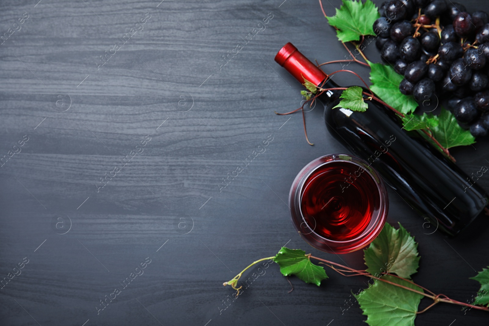 Photo of Flat lay composition with fresh ripe juicy grapes and space for text on wooden background