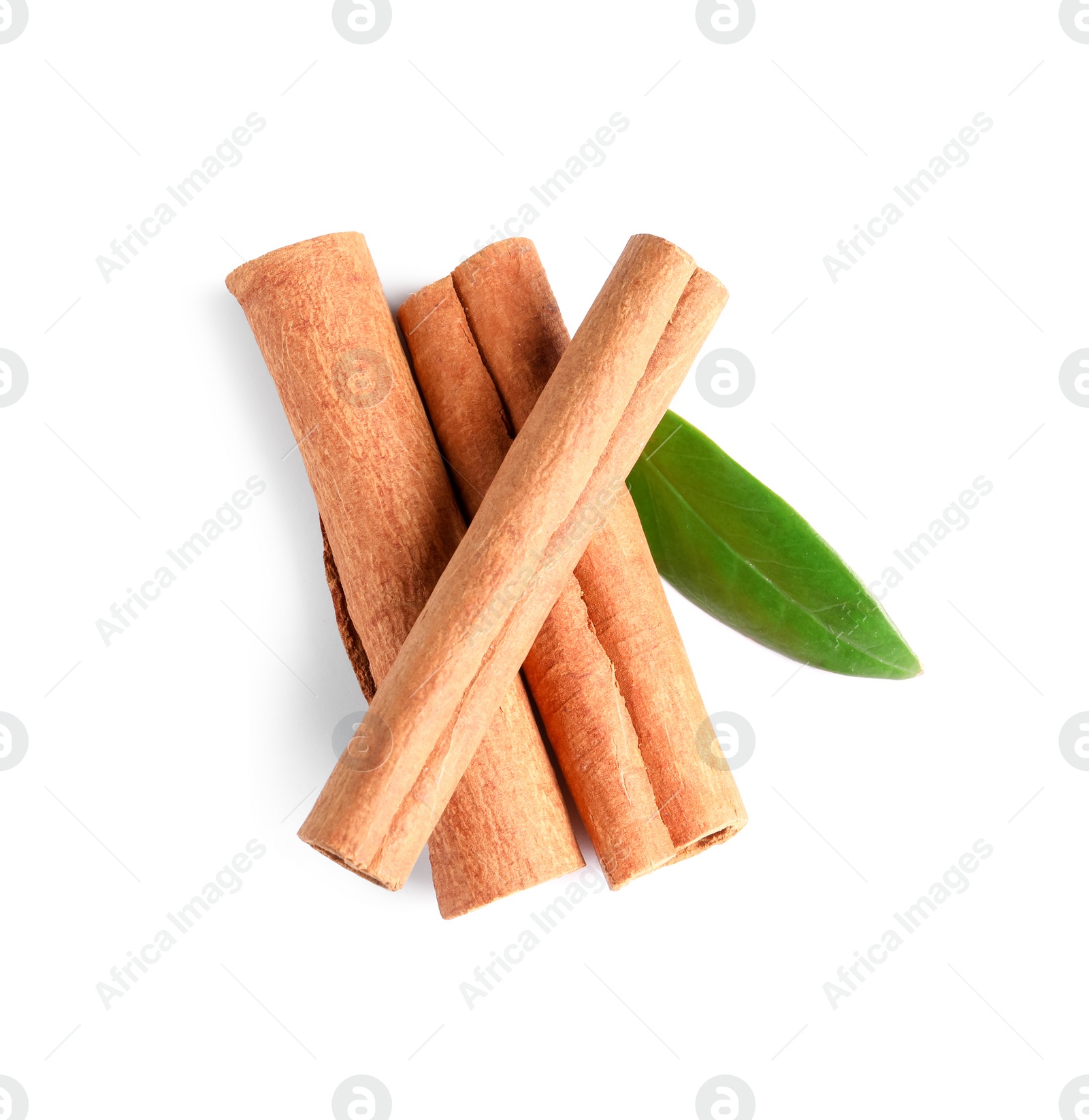 Photo of Cinnamon sticks and green leaf isolated on white, top view