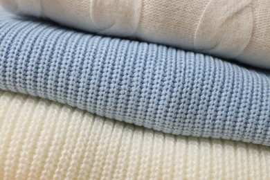 Closeup view of different warm folded sweaters as background