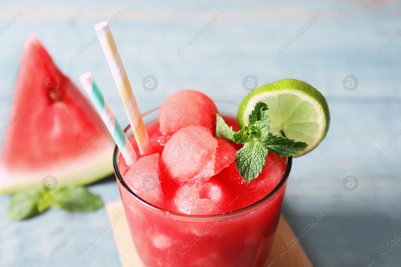 Photo of Summer watermelon drink with lime and mint on table, closeup