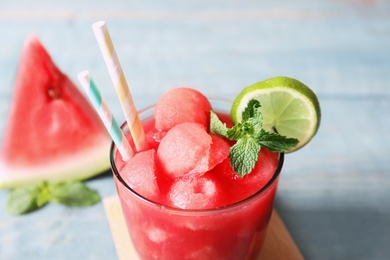 Photo of Summer watermelon drink with lime and mint on table, closeup