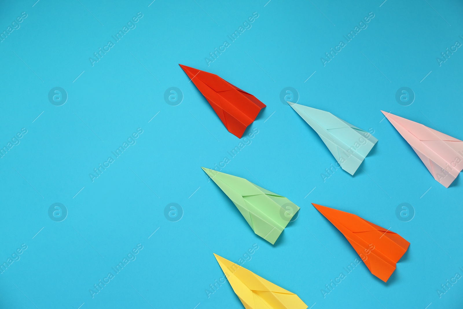 Photo of Flat lay composition with different paper planes on light blue background, space for text