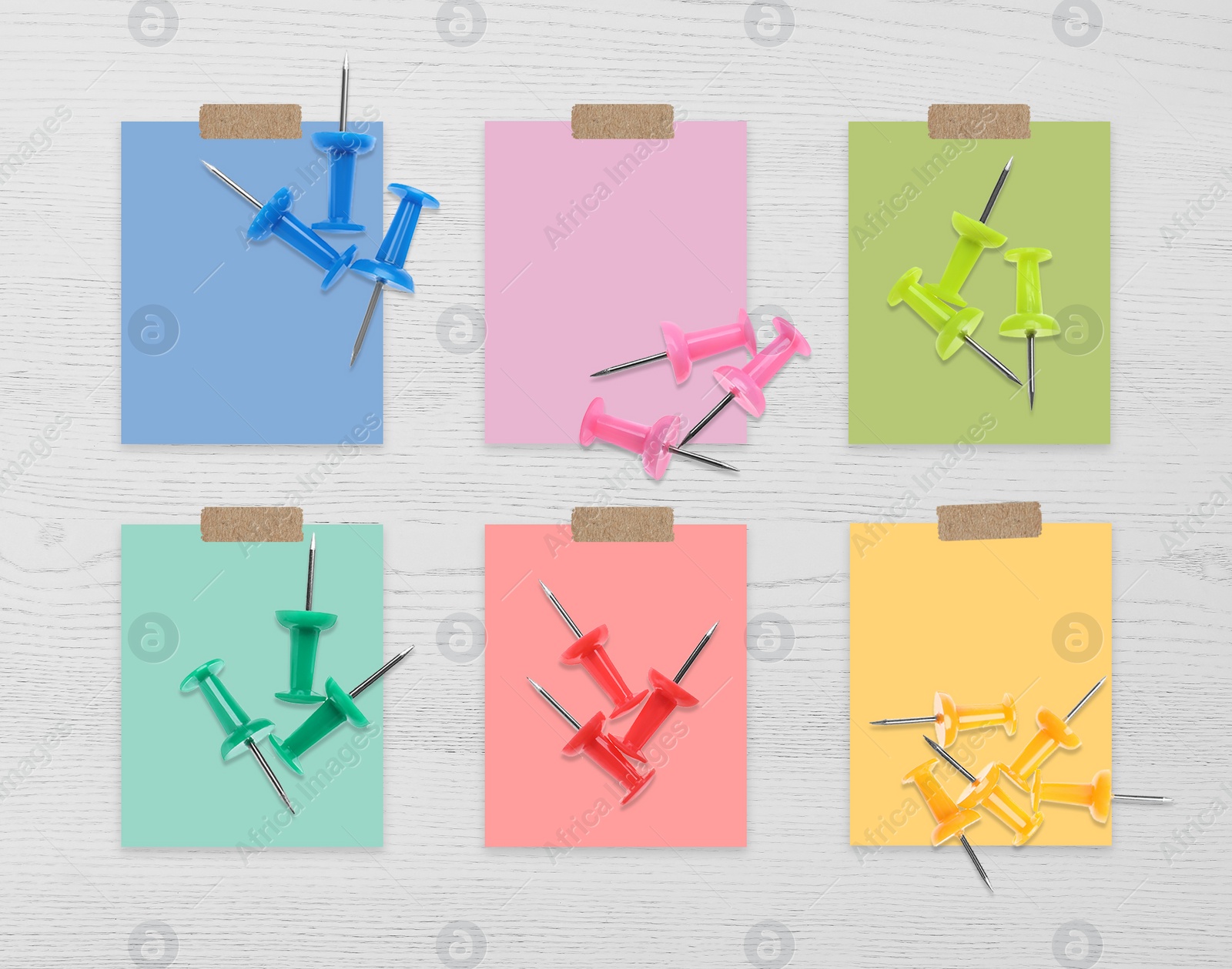 Image of Multicolor drawing pins and cards of similar shades on white wooden background, collage. Montessori method