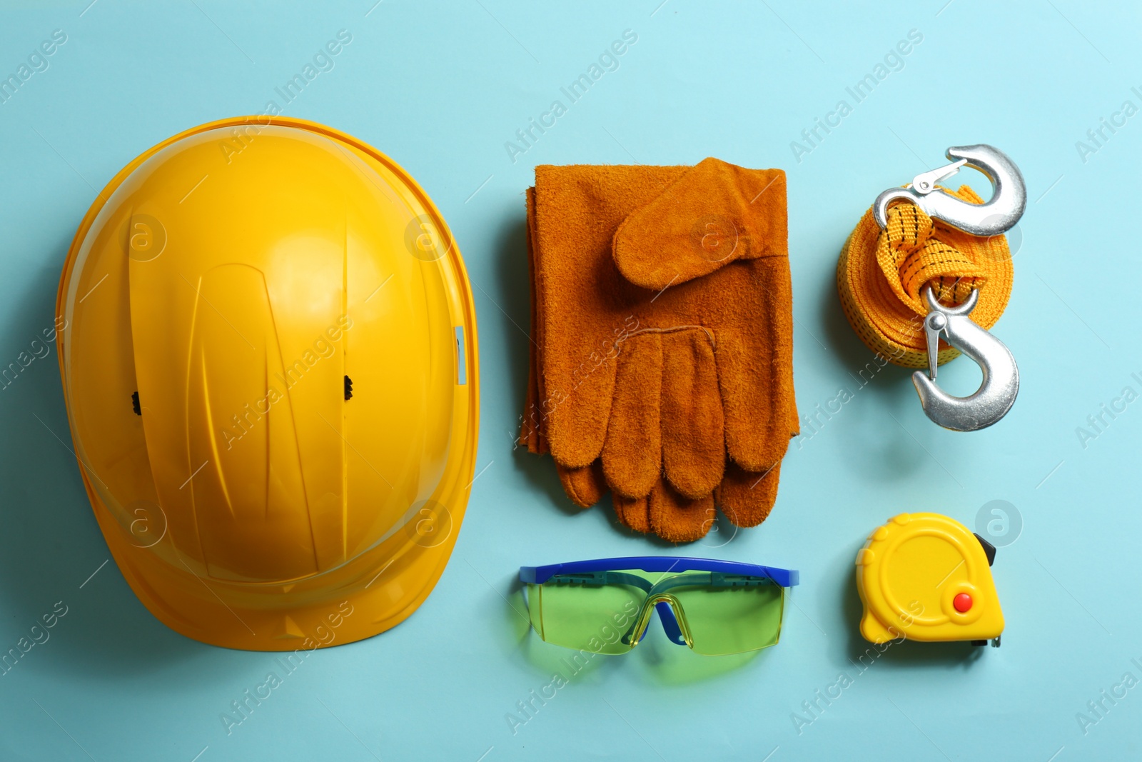 Photo of Flat lay composition with safety equipment on color background