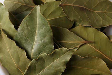 Photo of Pile of aromatic bay leaves as background, closeup