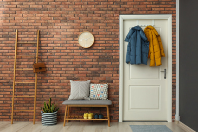 Hallway interior with stylish furniture, clothes and accessories