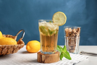 Photo of Glass of delicious mint julep cocktail on table