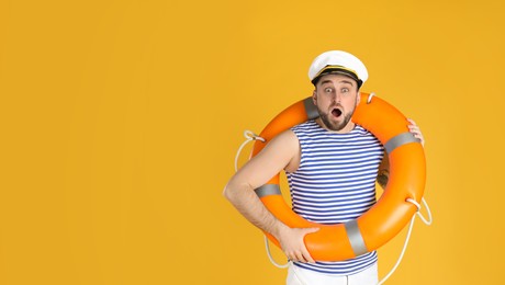 Emotional sailor with ring buoy on yellow background