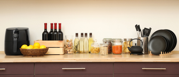 Stylish kitchen interior with wooden countertop and wall cabinets