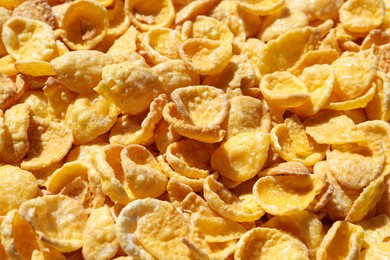 Photo of Crispy corn flakes as background, closeup view