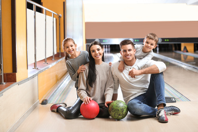 Happy family spending time together in bowling club