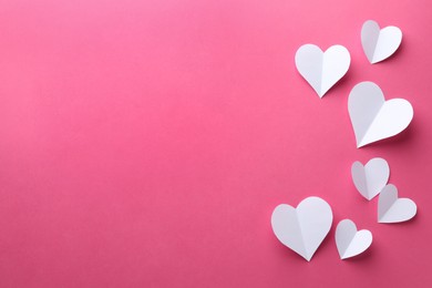 Photo of Paper hearts on pink background, flat lay. Space for text