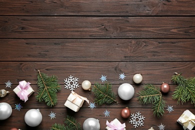 Flat lay composition with Christmas decorations on wooden background, space for text. Winter season