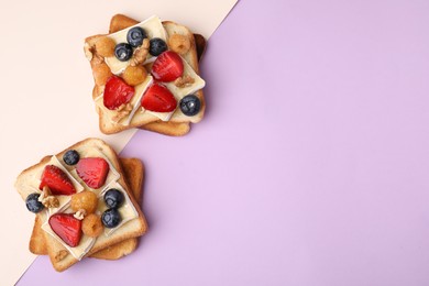 Photo of Tasty sandwiches with brie cheese, fresh berries and walnuts on color background, flat lay. Space for text