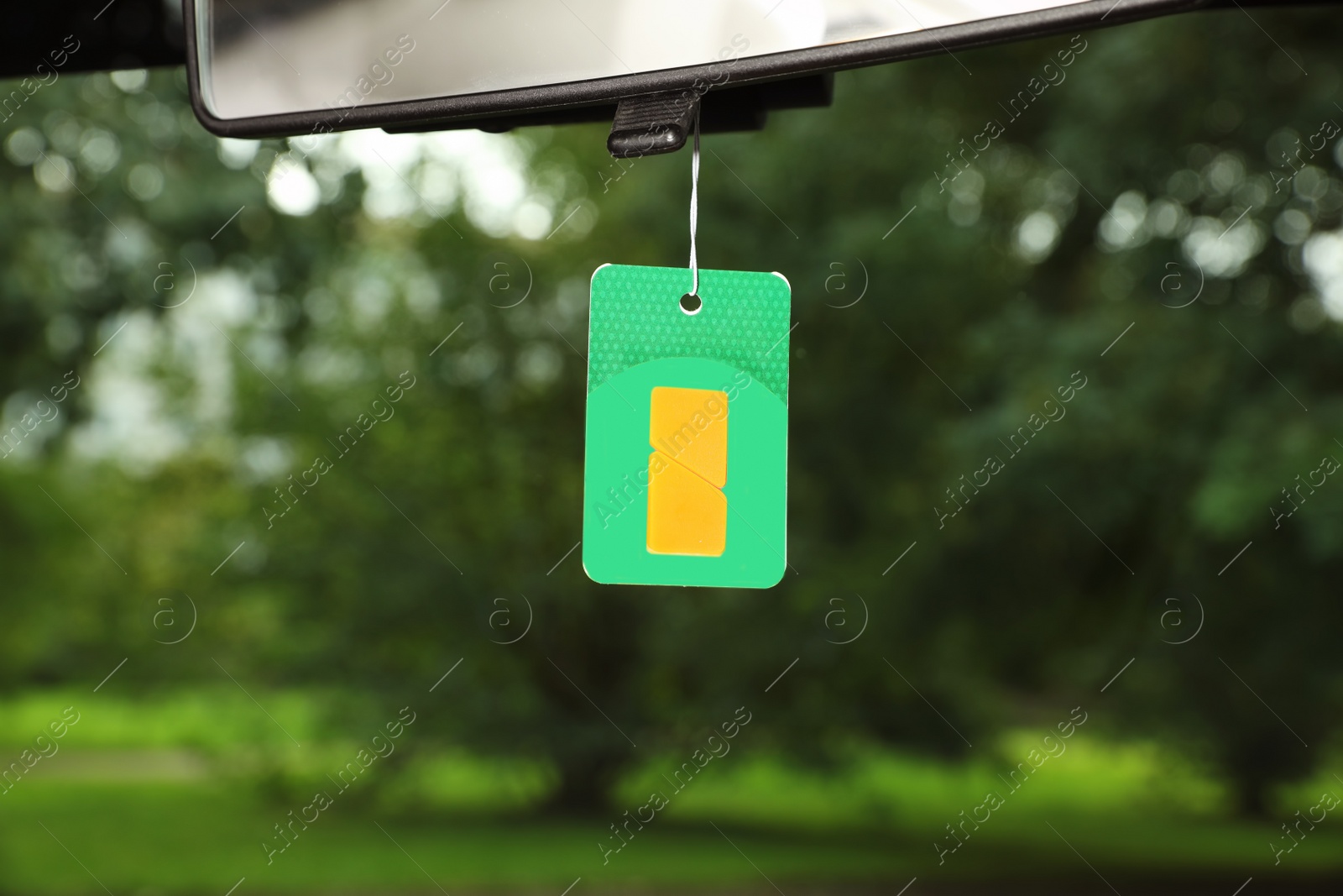 Photo of Air freshener hanging in car against windshield