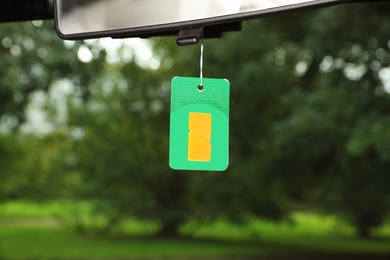 Photo of Air freshener hanging in car against windshield