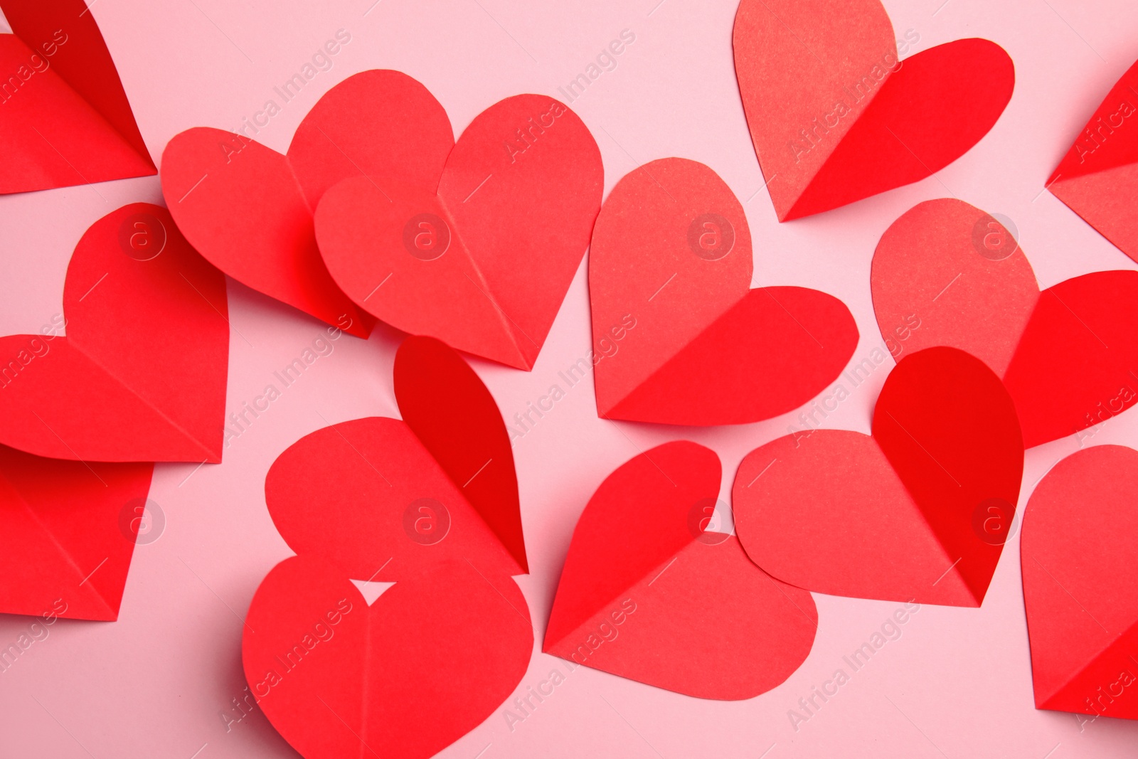 Photo of Small paper hearts on color background