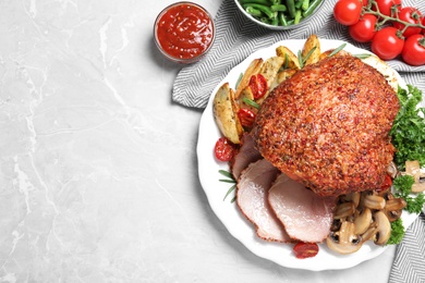 Homemade delicious ham on grey background, flat lay with space for text. Festive dinner