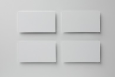 Blank business cards on white background, top view. Mockup for design