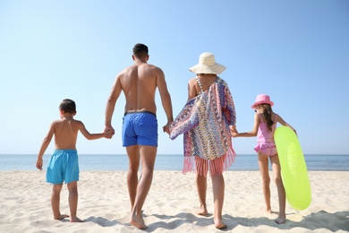 Photo of Family at beach on sunny summer day