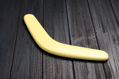 Photo of Boomerang on black wooden background. Outdoors activity