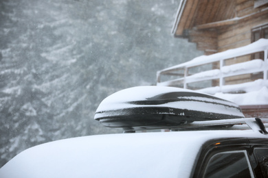 Photo of Modern car covered in snow outdoors on winter day, closeup