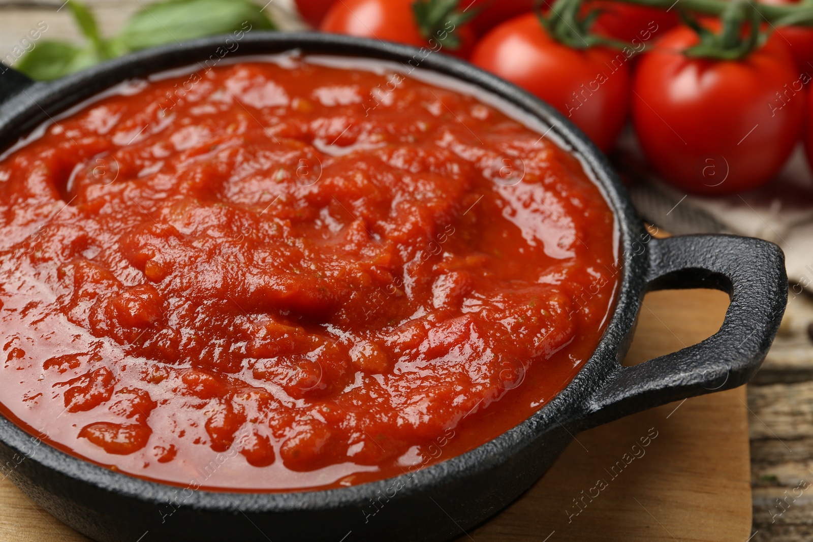 Photo of Homemade tomato sauce in bowl on table, closeup