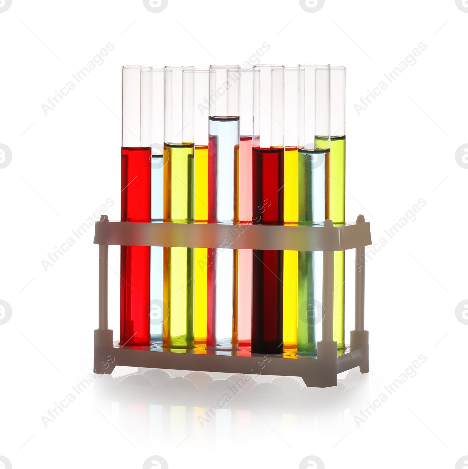 Photo of Rack with test tubes of color liquids isolated on white. Solution chemistry