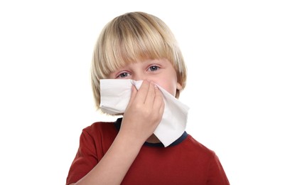 Photo of Boy blowing nose in tissue on white background. Cold symptoms