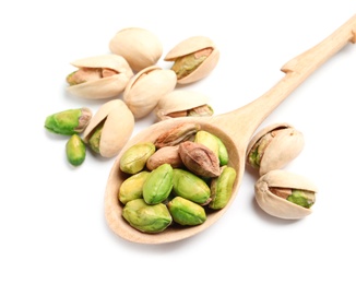 Photo of Organic pistachio nuts and spoon on white background, closeup