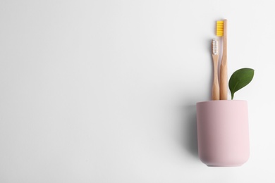 Flat lay composition with bamboo toothbrushes and space for text on white background