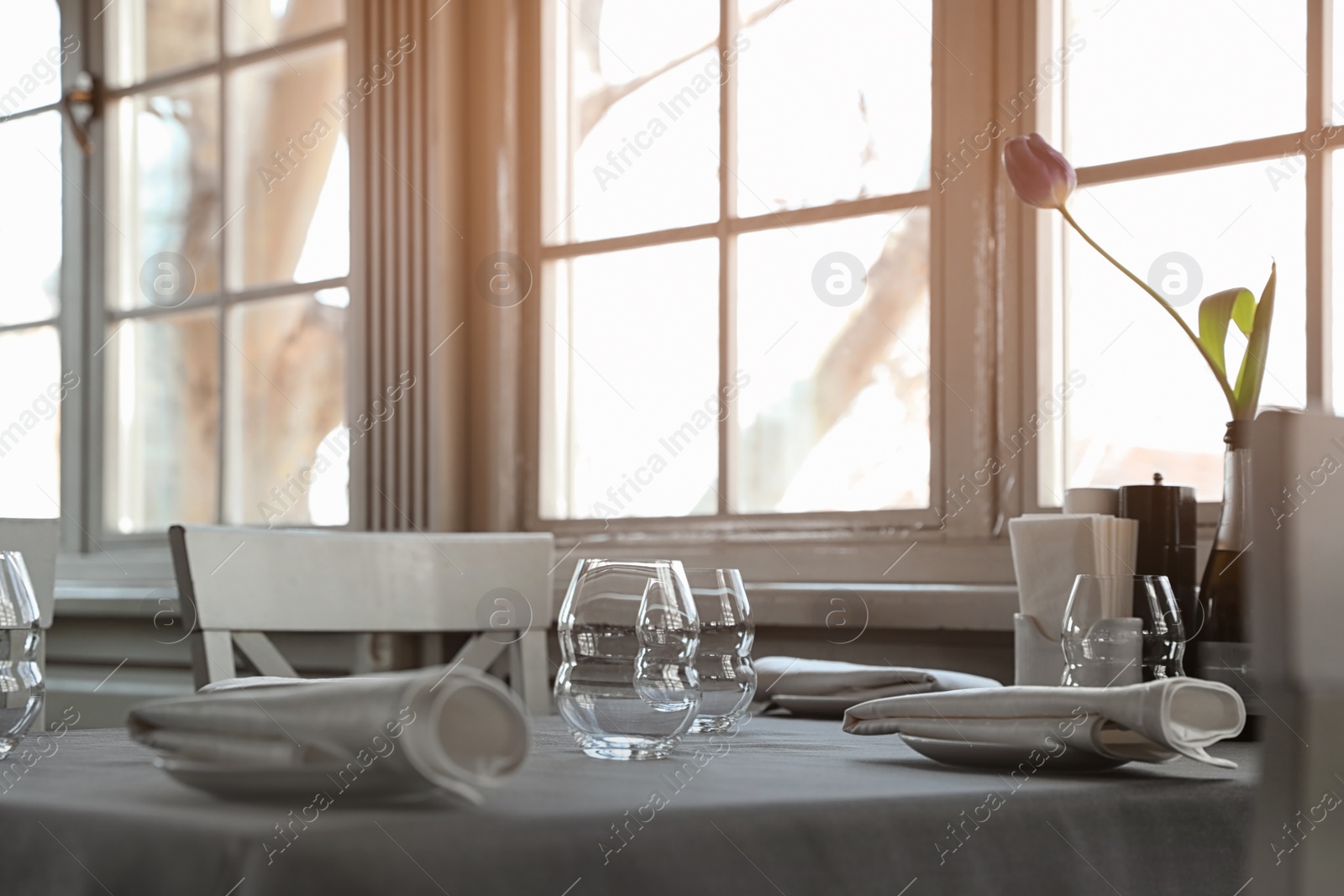 Table with plates and empty glasses in restaurant Photo of Table with plates and empty glasses in restaurant