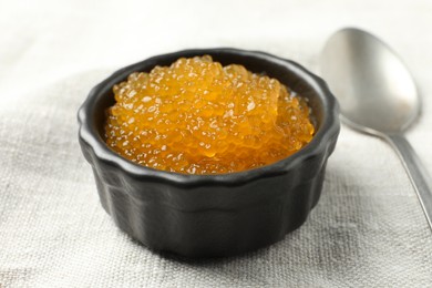 Photo of Fresh pike caviar in bowl on table, closeup