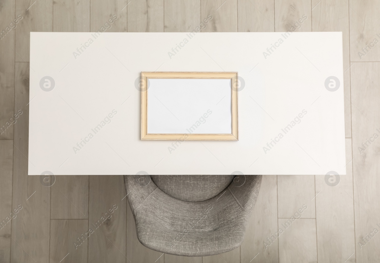 Photo of White table with photo frame near chair indoors, top view