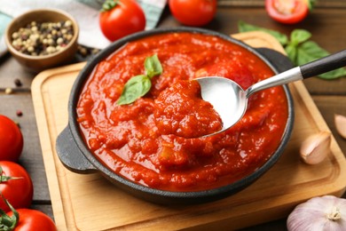 Photo of Eating homemade tomato sauce at table, closeup