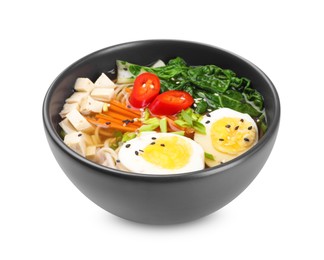 Photo of Delicious vegetarian ramen with egg, mushrooms, tofu and vegetables in bowl isolated on white. Noodle soup