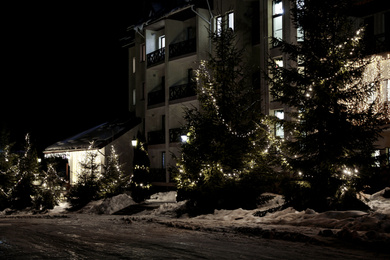 Photo of Beautiful modern hotel at night. Winter vacation