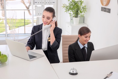 Photo of Female receptionists at workplace in hotel