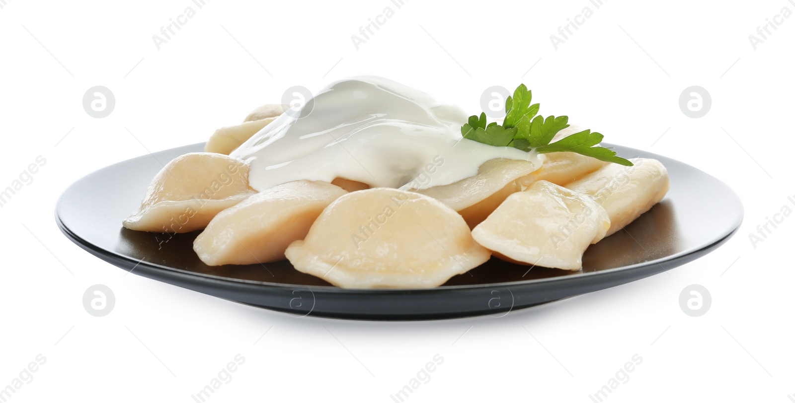 Photo of Delicious cooked dumplings with sour cream on white background