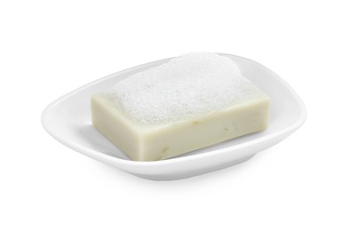 Photo of Soap bar with fluffy foam in holder on white background