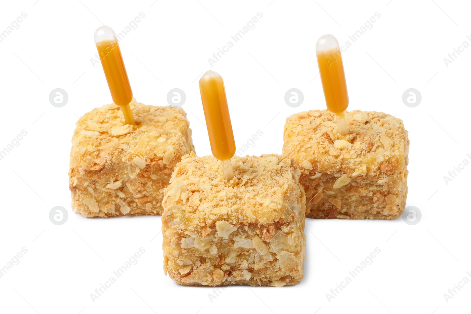 Photo of Pieces of Napoleon cake with jam pipette on white background