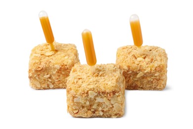 Pieces of Napoleon cake with jam pipette on white background