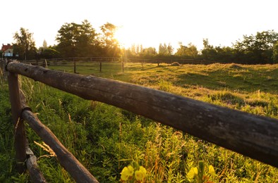 Photo of Picturesque view of countryside with wooden fence in morning