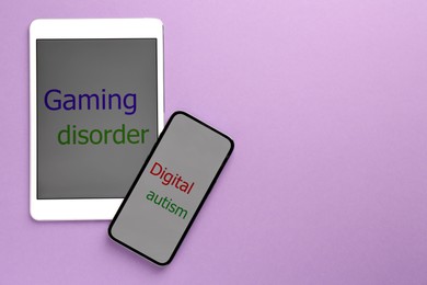 Photo of Addictive behavior. Tablet, smartphone with phrases Gaming Disorder and Digital Autism on violet background, flat lay. Space for text