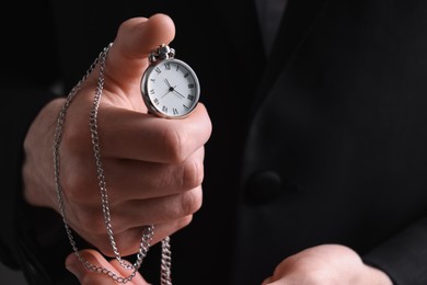 Man holding chain with elegant pocket watch, closeup