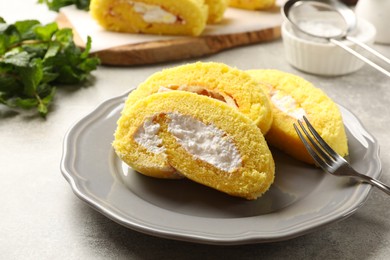 Photo of Delicious cake roll served on grey table, closeup