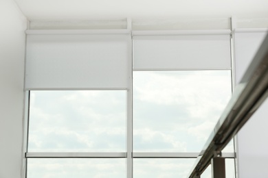 Photo of Large window with open roller blinds indoors